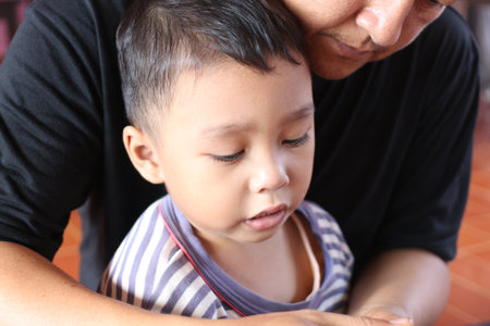 A heartwarming scene showcasing the strong bond between a child and parent, reflecting love and support in a close and intimate moment.の写真素材