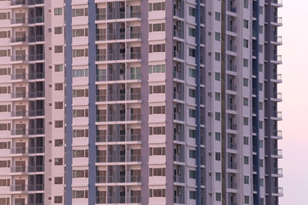 A detailed view of a contemporary high-rise building showcasing modern architectural elements and urban lifestyle, perfect for illustrating city living and architecture concepts.の写真素材