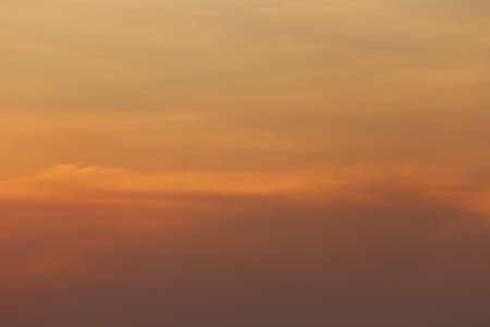 A beautiful display of a sunset with warm shades of orange and peach blending into the sky, creating...