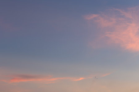A breathtaking twilight sky showcasing delicate shades of pink and blue, offering a calm and serene atmosphere ideal for art, photography, and design projects.の写真素材