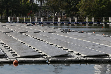 Floating solar panels set on a tranquil lake, demonstrating innovative technology in renewable...