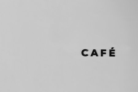 A striking minimalist cafÃ© sign featuring bold lettering on a soft background. This image captures a modern essence, perfect for showcasing cafÃ© culture and design trends.の写真素材