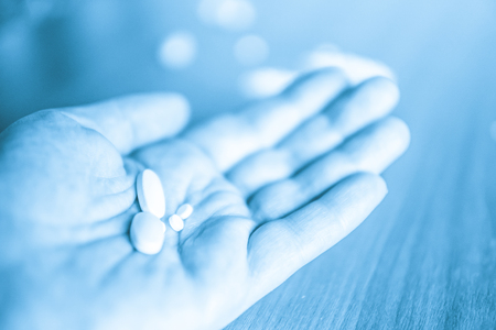 Person holding hand open with different presciption drugs for abuse.の写真素材