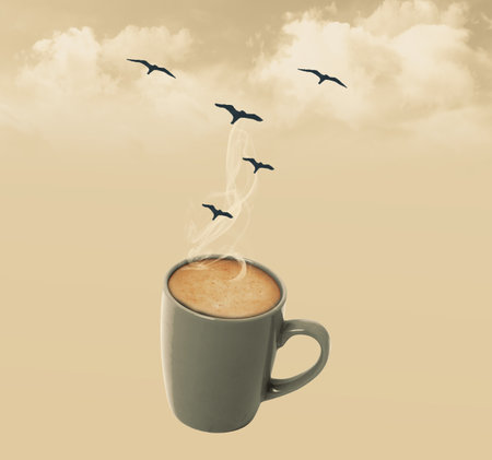 Coffee cup with steam, clouds and birdsの写真素材