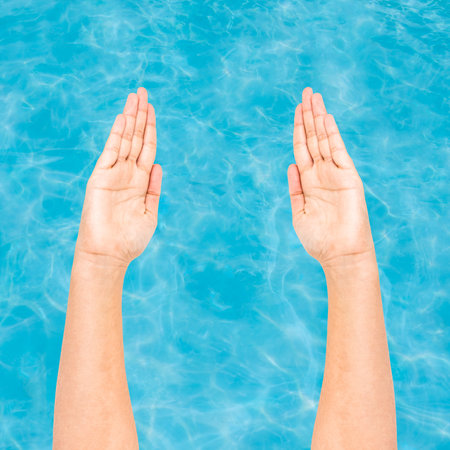 Hands preparing to swim with water backgroundの写真素材