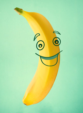 Funny cute yellow banana in cartoon face styleの写真素材