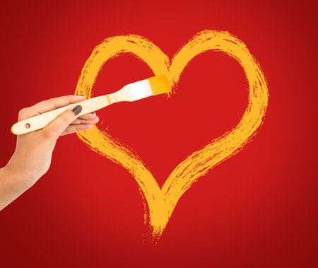 Hand painting heart shape on red wall backgroundの写真素材