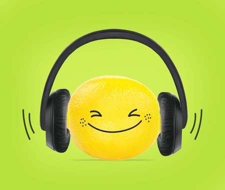Lemon wearing headphones concept on green background. Front viewの写真素材