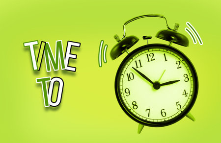 Green alarm clock isolated on white background with word Time To. Concept of Time