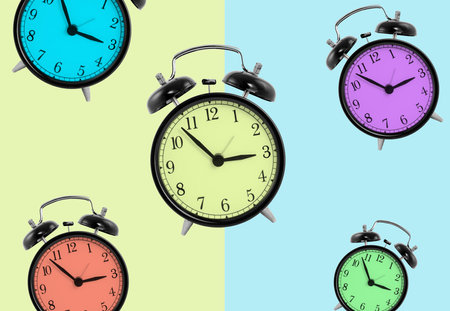 Clocks with different colors isolated on green and blue background