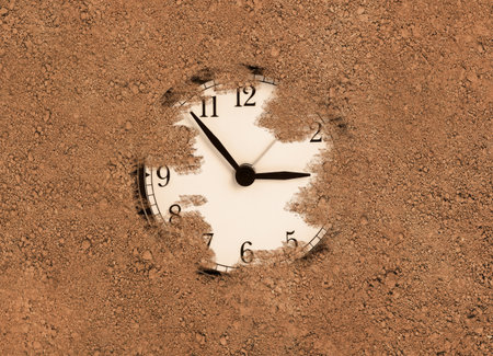 Black clock buried and lost in the sand. lost time conceptの写真素材