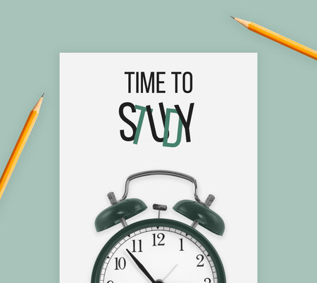 Time to study sentence on white paper and alarm clock with pencilsの写真素材