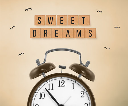 Alarm clock and the inscription SWEET DREAMS on a brown background. The concept of rest, sleep quality, good night, insomnia and relaxation. flat layの写真素材