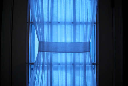 Sheer Curtain with Blue Lightの写真素材