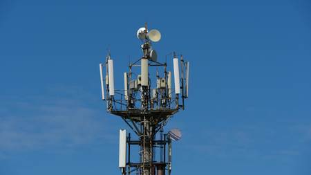 telecommunication cellular tower against blue sky, with room for copy spaceの写真素材
