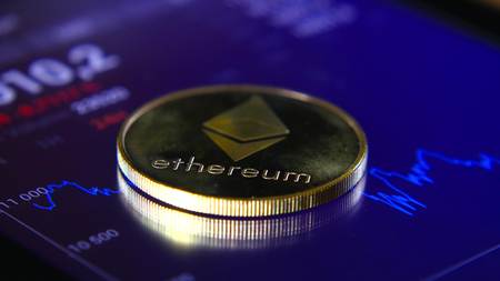 Gold coins of the ethereum on the background of a graphic stock chart. The Concentration of the Crypto-Currency of Virtual Moneyの写真素材