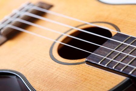 Small Hawaiian four stringed ukulele guitar body closeup. Musical instruments shop or learning school conceptの写真素材