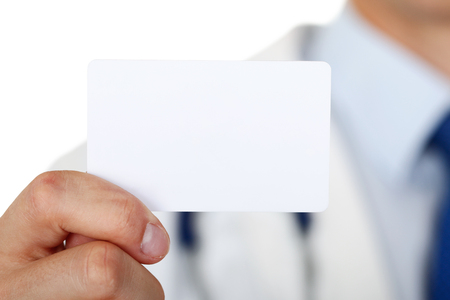 Male medicine doctor hand holding blank calling card.の写真素材