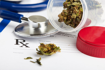 Medical marijuana in jar lying on prescription form near stethoscope. Cannabis recipe for personal use. Legal drugs conceptの写真素材
