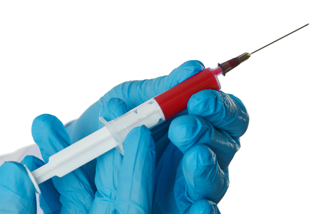 Medicine doctor hands in blue protective gloves holding syringe full of test blood isolated on white background closeup. Medical health, examination, laboratory or insurance conceptの写真素材