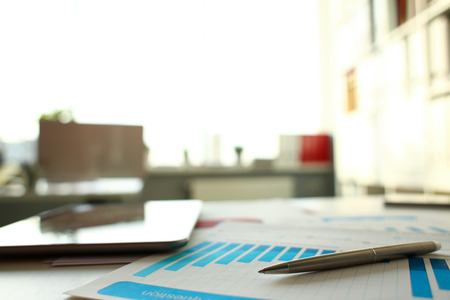 Silver pen lie at important paper on tableの写真素材