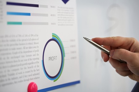 Male arm holding silver pen point in financial graph solving and discussing problem with colleague closeup. Situation examination at board council sale adviser job stock exchange market profitの写真素材