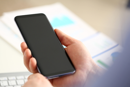 Businessman arm using modern cell phone closeup. Stock market trade and investment wireless ip telephony data search wifi connection inspiration idea web surf new browsing communication lifestyleの写真素材