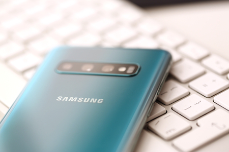 Minsk, Belarus - April 18, 2019: Samsung Galaxy s10 lying at silver keyboard closeup