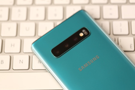 Minsk, Belarus - April 18, 2019: Samsung Galaxy s10 lying at silver keyboard closeupのeditorial素材