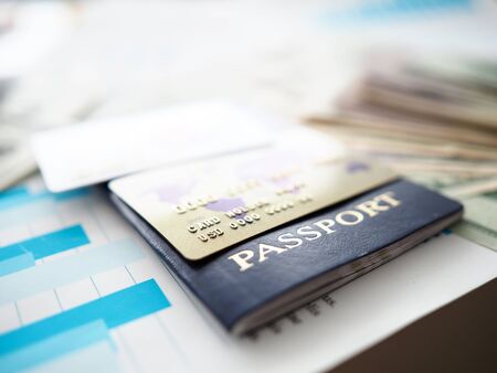 Passport and plastic cards in USD lying on financial report document closeupの写真素材