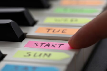 Male finger pressing piano key with start sign on it as begin of new lifestyle and sport activities and future achievements prospects conceptの写真素材