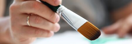 Letterbox view of male hand making drawing with watercolor brush closeupの写真素材