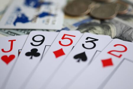 Playing cards lying at money stake with no decent combination close-up