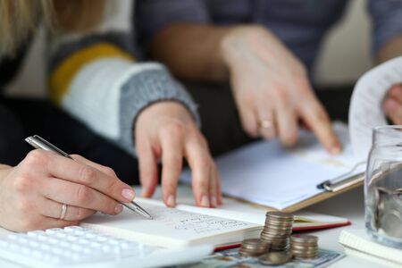 Close-up view of husband and wife calculating money balance. Family meeting to review and account credit and debit. Economical and financial problems conceptの写真素材