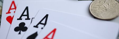 Letterbox view of playing cards lying at money stake with aces combination close-up