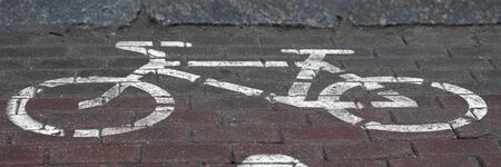 Bicycle parking sign painted on paint on asphalt. Bike storage system allows cyclists keep your...