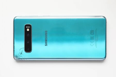 Barcelona, Spain - February 24, 2020: Samsung galaxy s10 smartphone with cracked back lid close-up