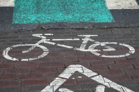 Bicycle parking sign painted on paint on asphalt. Bike storage system allows cyclists keep your bikes safe and in order. Organizing public spaces and increasing the attractiveness cyclingの写真素材
