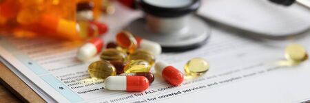 Medical capsules are scattered on medical insurance. Disease prevention, dietary supplements in capsules. Correct selection drugs, taking into account state health and individual characteristics bodyの写真素材