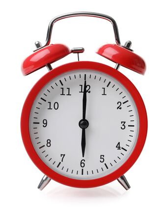Red alarm clock set at six isolated over white background close-up with clipping pathの写真素材