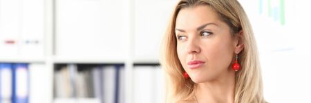 Portrait of pretty businesslady looking away with interest and gladness. Beautiful businesswoman in black and white stylish dress. Business meeting and company conceptの写真素材