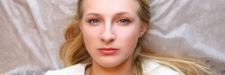 Girl waiting for eyebrow permanent procedure. Desired shape and volume eyebrows is created. Hairs fill in gaps, look thin and natural. Skin regeneration. Girl experimenting with imagesの写真素材