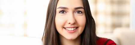 Portrait beautiful brunette girl in red dress. Close-up cheerful smiling face young woman. Healthy...