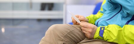 Close-up of person sitting indoors in bank or other organization. Copy space in left side. Name tag...