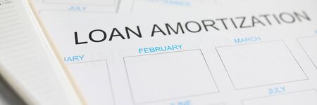 Loan amortization paper plan lying at worktable ready to be filled close-upの写真素材