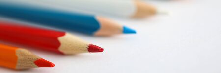 Close-up of pencils laying on blank paper, multicolor pens for drawing. School or office supplies for writing or highlighting information. Assortment for kids in kindergartenの写真素材