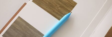 Top view of material samples. Floor or wall cover. Blue pen on desktop. Professional interior design...