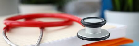 Close-up of stethoscope lying on table. Medical instrument for listening to action of heart or breathing. Medic office interior. Healthcare and prevention conceptの写真素材