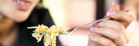 Close-up of smiling businesswoman having dinner. Happy businesslady relaxing from hard job in restaurant. Woman in restaurant. Lunch break at work conceptの写真素材