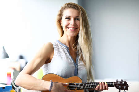 Portrait of happy woman looking at camera with calmness and happiness. Smiling female person playing...
